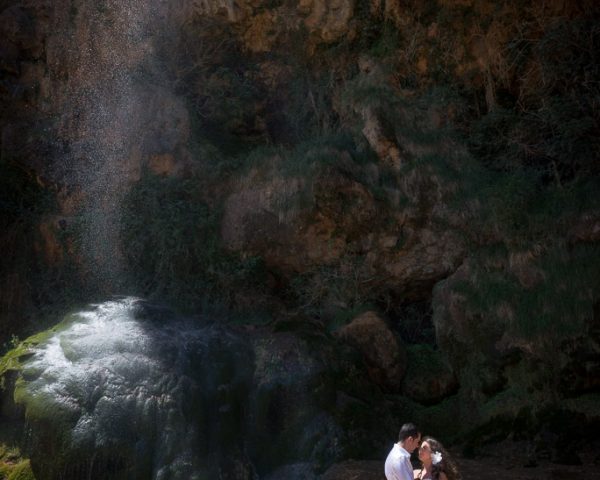 A young couple getting a photo session at the Bridal Veil waterfall during the hot springs tour