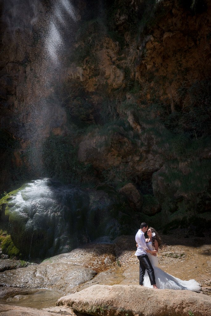 A young couple getting a photo session at the Bridal Veil waterfall during the hot springs tour